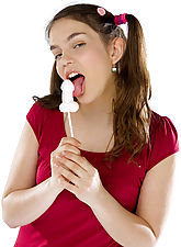 Cute pigtailed teen stripping in studio with lollipop...